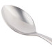 A close-up of a World Tableware stainless steel dessert spoon with a silver handle.