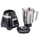 A Waring bar blender with a silver container and black and silver electronic keypad controls on a counter in a professional kitchen.