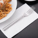 A Libbey Cimarron stainless steel dinner fork on a plate of pasta.