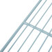 A close-up of a white coated metal grid shelf.