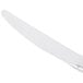 A silver Libbey stainless steel dinner knife with a white handle.