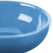 A close-up of a blue bowl with a white swirl on the inside.
