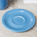 A Libbey blue porcelain saucer on a table.
