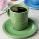 A green Libbey Cantina saucer with a drink on it.