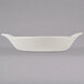 A white Hall China au gratin dish with handles.