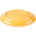 A yellow oval porcelain platter with a white swirl design.