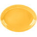 A yellow oval Libbey Cantina porcelain platter with a wavy edge.