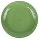 A close-up of a green Libbey Cantina porcelain plate with a circular carved design.