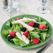 A Libbey sage green porcelain plate with a salad of spinach, berries, and chicken.