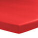 A red rectangular tablecloth with elastic.