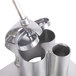 A stainless steel Robot Coupe food processor feed head with a metal handle.