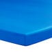 A blue surface with a white background. A Creative Converting Royal Blue rectangular tablecloth with elastic.