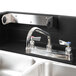 A Cambro CamKiosk portable self-contained hand sink with a gray door over a sink and faucet.