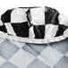 A crumpled black and white checkered plastic tablecloth.