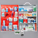 A white Lavex first aid kit cabinet with four shelves holding a variety of first aid supplies.