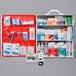 A Lavex first aid kit cabinet with a red cover and various first aid items inside.