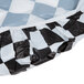 A white rectangular plastic tablecloth with a black and white checkered pattern and elastic edges.