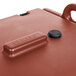 A red Cambro insulated soup carrier on a table.
