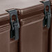 A close up of a dark brown plastic box with black metal latches.