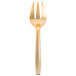 A close-up of a Fineline gold serving fork with a white handle.