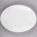 A Tuxton bright white oval china platter with an embossed rim.