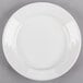 A Tuxton Pacifica bright white china plate with an embossed white rim.
