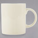 A white porcelain mug with a C-handle.