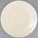 A white porcelain bread and butter plate with a white rim on a gray background.