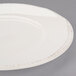 A Libbey Farmhouse ivory porcelain plate with a wide brown rim.
