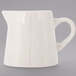 A white pitcher with a white handle.