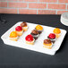 A Libbey ultra bright white porcelain tray with cupcakes on a table.