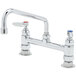 A chrome T&S deck-mounted faucet with two lever handles and an 8" swing nozzle.