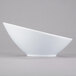 A Libbey Chef's Selection II white porcelain Belmar bowl with a curved edge.