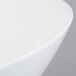 A close-up of a Libbey Ultra Bright White Belmar bowl with a curved rim.