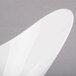 A close up of a Libbey ultra bright white porcelain Riviera bowl with a curved edge.