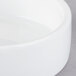 A close up of a Libbey ultra bright white porcelain disk bowl on a white surface.