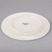 A white porcelain plate with a medium rim.