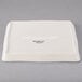 A white square Libbey porcelain tray with a logo on it.