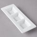 A white rectangular porcelain tray with three square wells.