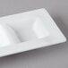 A white rectangular porcelain tray with three square wells.