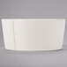 A Libbey Farmhouse ivory porcelain oatmeal bowl with a curved edge on a gray background.