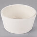 A Libbey Farmhouse ivory porcelain sauce bowl with a small hole in the middle.