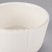 A close up of a Libbey Farmhouse ivory porcelain sauce bowl with a brown rim.