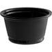 A black Choice plastic souffle cup on a white table.