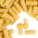A pile of Regal Rigatoni pasta on a white surface.