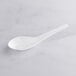 A Visions white plastic Asian soup spoon on a white surface.