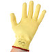 A yellow Cordova cut resistant glove with a red band.