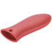 A red silicone Lodge handle holder with a hole for a skillet handle.