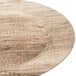 A close up of a Charge It by Jay faux wood melamine charger plate.