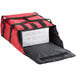 A red ServIt insulated delivery bag holding pizza boxes.